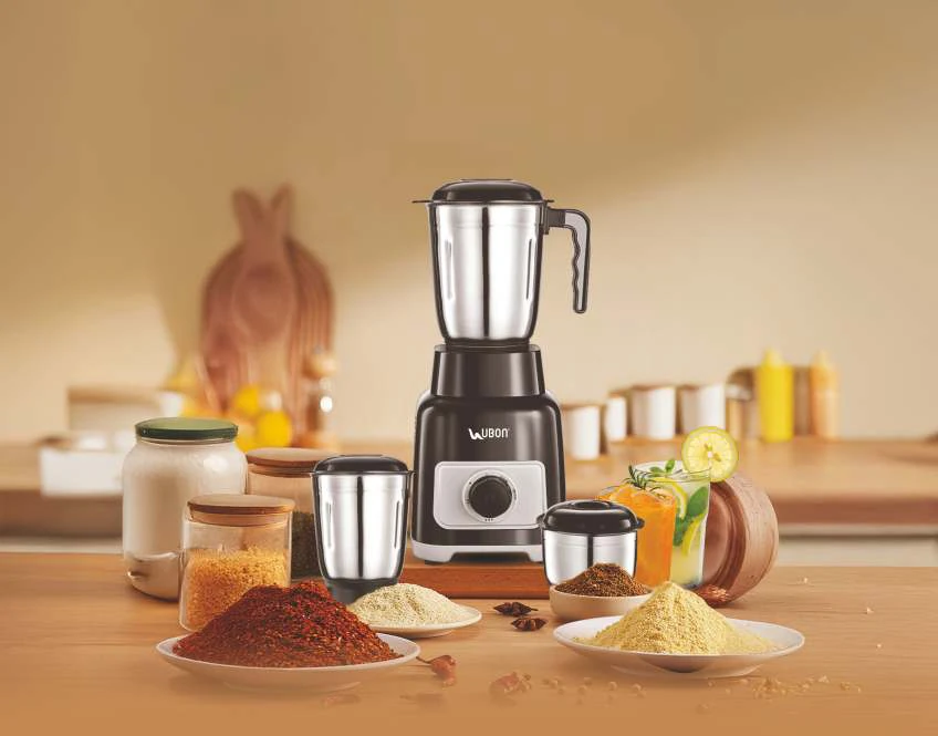 Ubon MixPro mixer grinder on a kitchen counter with spices and fresh juice
